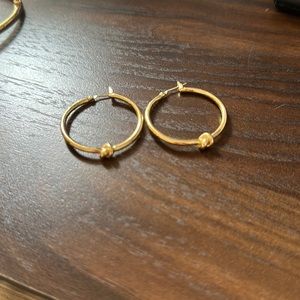 Kate Spade gold hoop with “friendship” knot design.